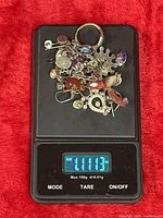 Assorted sterling silver jewellery on digital scale showing 1.111 oz