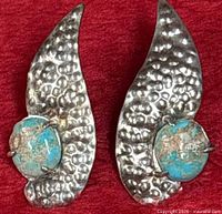 Front view showing both hammered sterling silver earrings with turquoise stones