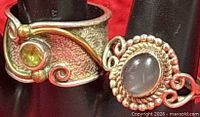 Close-up of both rings showing gemstones, metal detail