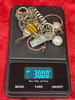 All scrap jewellery pieces on digital scale reading 31.00 g