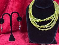 Necklace on bust form and earrings on stand