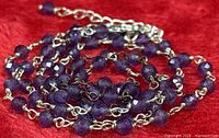 Coiled view showing sterling links and faceted amethyst beads