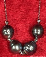 Close-up of central pearls and silver beads on chain