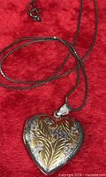 Heart locket pendant and portion of chain showing clasp