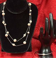 Necklace displayed on bust; bracelet on hand form