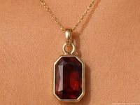 Pendant worn on chain showing rectangular stone and bezel