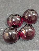 Four round garnet cabochons close-up