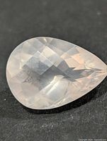 Top view of pear-cut rose quartz showing faceting and color