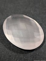 Top view of oval rose quartz showing overall shape and faceting