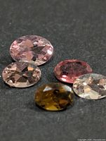 Five loose oval tourmaline gemstones in mixed colours