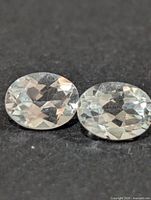 Top view of both oval white topaz stones