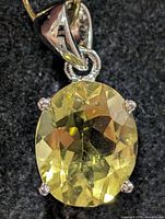 Front view of lemon quartz pendant showing stone and prongs