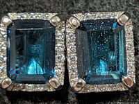 Front view of both earrings showing blue topaz and CZ halo