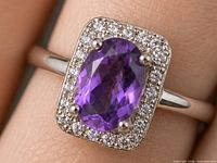 Ring on finger showing amethyst and CZ halo