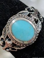 Front view showing turquoise cabochon and ornate band