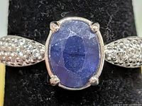Frontal view of ring showing sapphire and CZ shoulders