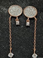 front view showing pavé CZ tops, chain, and CZ drops of both earrings
