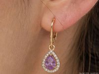 Earring worn in ear showing size, pear amethyst with CZ halo and leverback