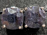 Front view of both cushion-cut dyed sapphire earrings in prong settings