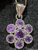 Front view of silver pendant with seven amethysts