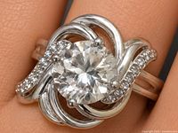 Top view of silver ring showing white quartz center and CZ accents