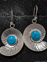Front view of both silver spiral earrings with turquoise stones