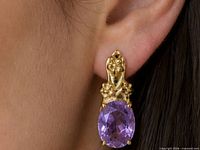 Earring worn on ear showing size and design