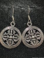 front view of both earrings on black background