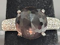 Top view showing round faceted brown gemstone and CZ-set shoulders