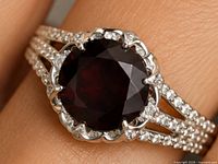 Close-up of ring on finger showing garnet and CZ details