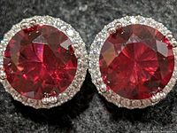 Front view showing round red center stones and CZ halos