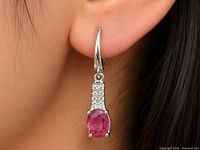 earring worn in ear showing scale and design