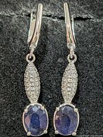 Front view of both silver drop earrings showing sapphires and CZ pavé