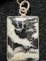 Front view of pendant showing zebra quartz pattern and silver bezel
