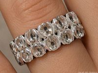 Ring on finger showing stone arrangement and overall design