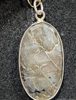 Front view of oval labradorite pendant in silver bezel