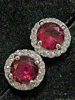 Front view of both earrings showing ruby centres and CZ halos
