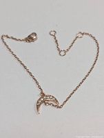 Full view of bracelet showing chain, clasp and crescent moon CZ charm