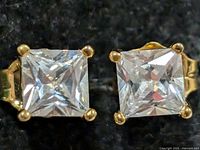 Front view showing both square CZ stones and prong settings