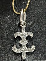 Front view of silver pendant showing pavé cubic zirconia and overall shape