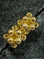 Front view of one earring showing bead cluster design