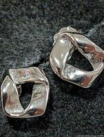 Front view of both earrings showing design and finish