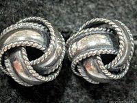 front view of both silver knot earrings