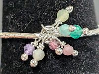 Close-up of gemstone cluster on silver ring