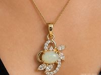 Pendant worn on chain showing proportion and stone details