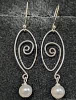 Front view of both earrings showing spiral design and pearls