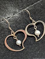 Front view of both earrings showing heart shape and pearls