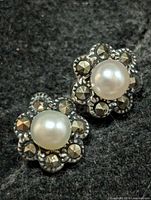 Front view of both earrings showing pearls and marcasite flower setting