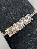 Close-up of three-stone setting on silver ring