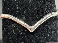 front view of silver chevron ring on display stand